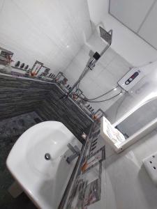 a bathroom with a white sink and a shower at CHEN VILLA - Near Airport in Negombo