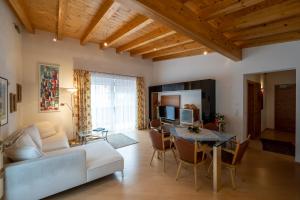 a living room with a couch and a table at Försterhaus & Haus Andrea in Mayrhofen