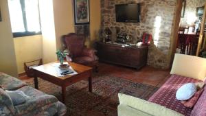 a living room with a couch and a table at Casa pedrolo in Outes