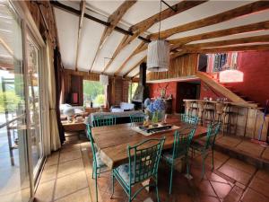 a dining room with a wooden table and chairs at Hostal Macal in Talca