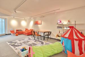 a living room with a table and a play tent at Residenz Ostseestrand Appartement 26 in Scharbeutz