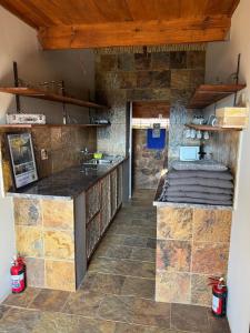 a kitchen with stone walls and a counter top at JUMANJI NATURE RESORT in Hartbeespoort