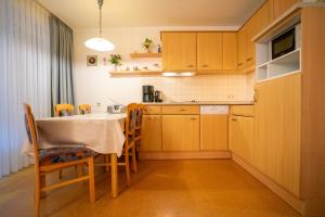 a kitchen with a table and chairs in a room at Felber in Büsum
