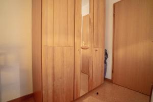 a wooden door in a room with a hallway at Felber in Büsum