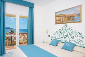 a bedroom with a bed and a view of the ocean at Hotel Biodola in Portoferraio +34 photos