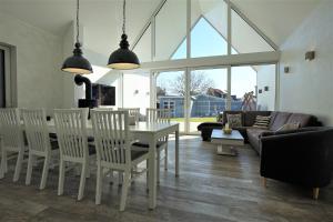 a dining room and living room with a table and chairs at Witte Bank in Büsum