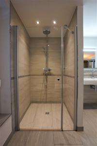 a shower with a glass door in a bathroom at Witte Bank in Büsum +16 photos