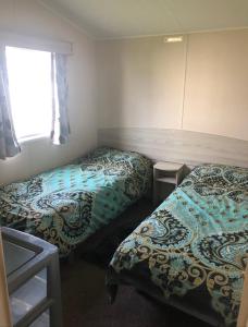 a bedroom with two beds and a window at Marton mere in Blackpool