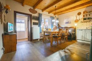 a kitchen and dining room with a table and chairs at Godewind Haus Wattwurm in Büsum +7 photos