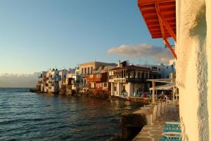 a group of buildings next to the water at Mykonos Loft in Mikonos