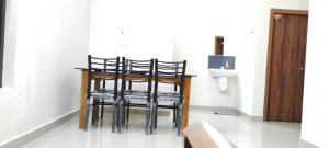 a group of stools in a bathroom with a toilet at Eve's appartment in Meppādi