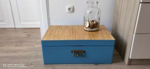 a blue chest with a vase on top of it at Guesthouse Palma in Mali Lošinj