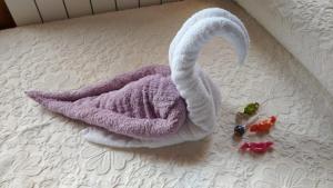 a towel shaped like a swan on a bed at Casa pedrolo in Outes