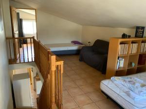 a small room with a couch and a bed in it at La Perdrix in Argelès-sur-Mer