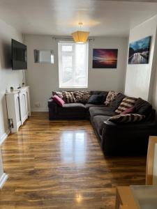 a living room with two couches and a wooden floor at TownHouse near Beach Bournemouth in Bournemouth