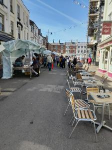 a group of tables and chairs on a city street at The Little House Louth in Louth