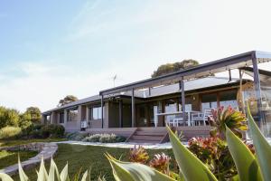 a house with a garden in front of it at Miravino, winery stay with outdoor sauna and spa in McLaren Vale