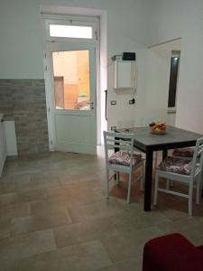 a dining room with a table and two chairs at Casa Sofia in Castelsardo +1 photo