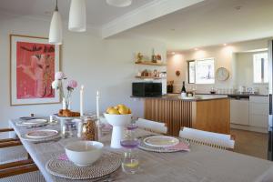a kitchen and dining room with a table and chairs at Miravino – breathtaking vineyard views in McLaren Vale