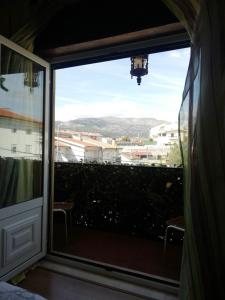 a window in a room with a view of a city at Alojamento Local Casa Veras in Vila Real