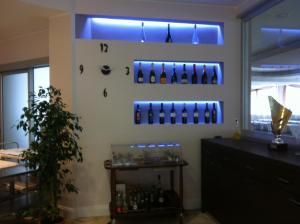 a bar with wine bottles on the wall at Hotel Ristorante Sbranetta in Rozzano