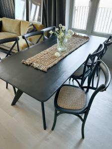 サレンにあるFjällglim36の黒いテーブルと椅子、花瓶