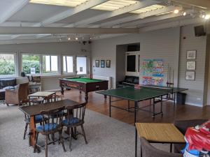a living room with two ping pong tables and chairs at Corriefodly Holiday Park in Blairgowrie +28 photos