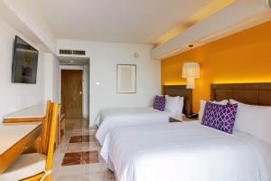 a hotel room with two beds and a desk at Camino Real Veracruz in Veracruz