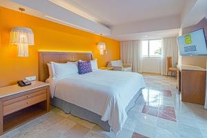 a hotel room with a bed and a television at Camino Real Veracruz in Veracruz