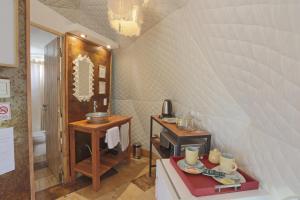 a bathroom with a sink and a table with a mirror at Glamping Tafí del valle in Tafí del Valle