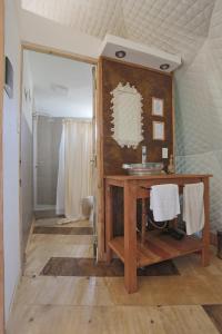 a bathroom with a wooden vanity and a sink at Glamping Tafí del valle in Tafí del Valle