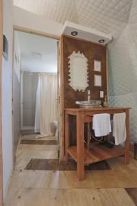 a bathroom with a wooden vanity and a sink at Ecoglamping Tafí del Valle in Tafí del Valle