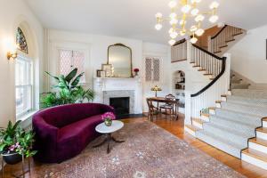 里士满The Boulevard Inn的一间带紫色沙发和楼梯的客厅