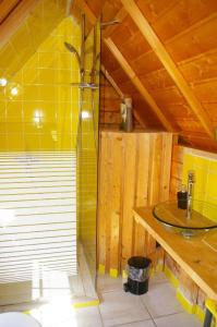 uma casa de banho com um chuveiro e um lavatório. em village privatisé de cabanes insolites d'Ananda Ma em Saint-Aubin-de-Lanquais