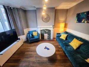 a living room with a couch and a table and a tv at House near restaurants, park and pubs, perfect for pets! in Bristol