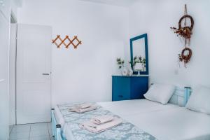a bedroom with a bed with two towels on it at Dimitra's Sunset View Apartment in Kalivia Poligirou