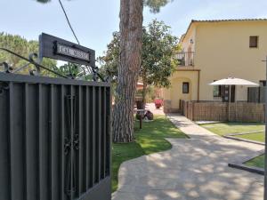 a gate with a street sign on it next to a house at Cal Music B&B in Premia de Dalt