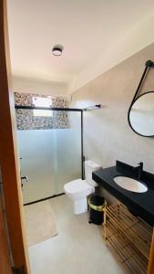 a bathroom with a toilet and a sink and a shower at Vila Dos Diamantes - Lencois Bahia in Lençóis