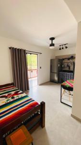 a living room with a bed and a kitchen at Vila Dos Diamantes - Lencois Bahia in Lençóis