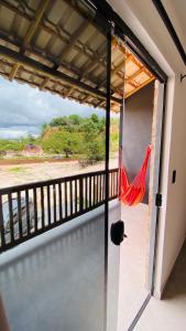 a view from the balcony of a room with a hammock at Vila Dos Diamantes - Lencois Bahia in Lençóis