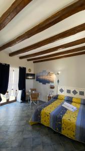 a bedroom with a large bed and a table at Dal Duomo al Mare Cefalù in Cefalù