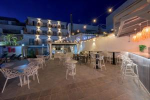 a patio with tables and chairs at night at Hotel Boutique Sibarys - Adults Recommended in Nerja