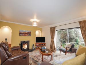 a living room with a couch and a fireplace at 20 South High Street in Portsoy