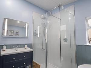 a bathroom with a shower and a sink at 20 South High Street in Portsoy +22 photos