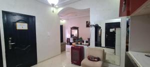 a hallway with a black door and a chair at Mohammed V Airport HOME in Deroua