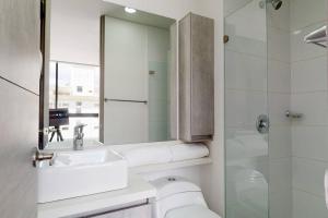 y baño con aseo, lavabo y espejo. en Apartamento 601 kappadoccia, en Bogotá