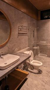 La salle de bains est pourvue de toilettes et d'un lavabo. dans l'établissement Cottonwood Exclusive Villa Sagarmatha @Puncak, à Bogor