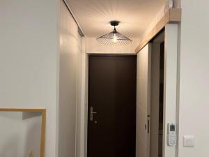 un couloir avec une porte noire et un plafond dans l'établissement *La Pampa, Studio, Parking, Clim, Hôpitaux/Fac*, à Montpellier