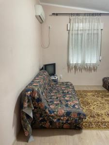 uma cama num quarto com um cobertor em Apartment Lazar & Marco em Podgorica