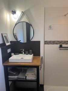 a bathroom with a sink and a mirror at Gîtes dans Mas en pierres in Robion en Luberon